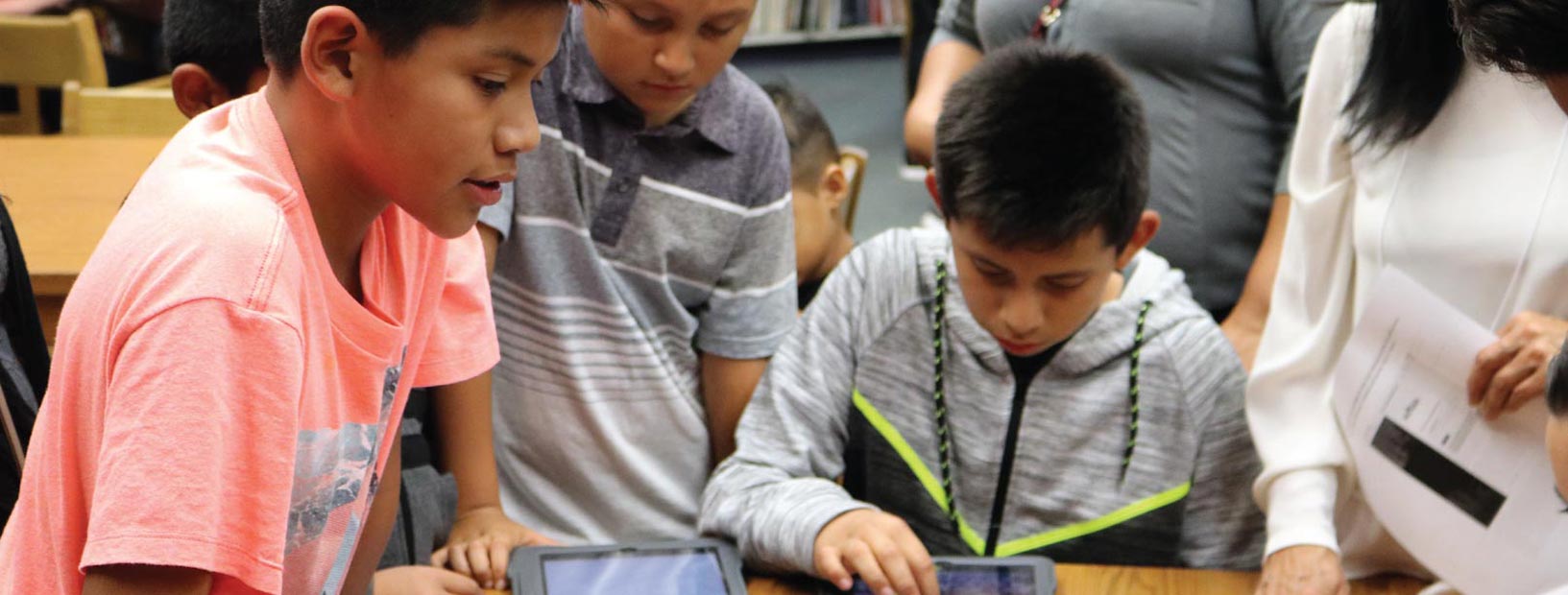 Kids writing at a desk