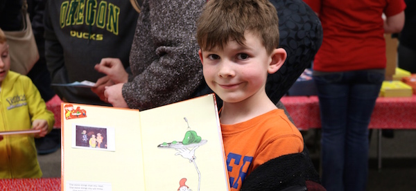 Wilkes Boy smiling with book