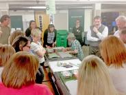 Open House attendees gather around mock-ups for the new Wilkes Elementary