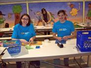 PCC Volunteers repairing books.