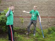 Volunteers clearing weeds from flower beds