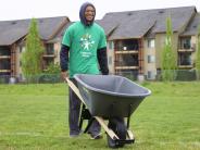 High school volunteer moves bark dust