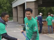 High school volunteer moves bark dust