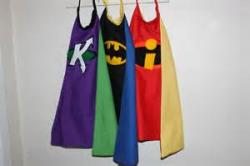 Superhero capes hanging on a hook