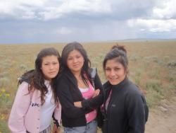 Photo of three female RLA students with brown hair on a field trip. 