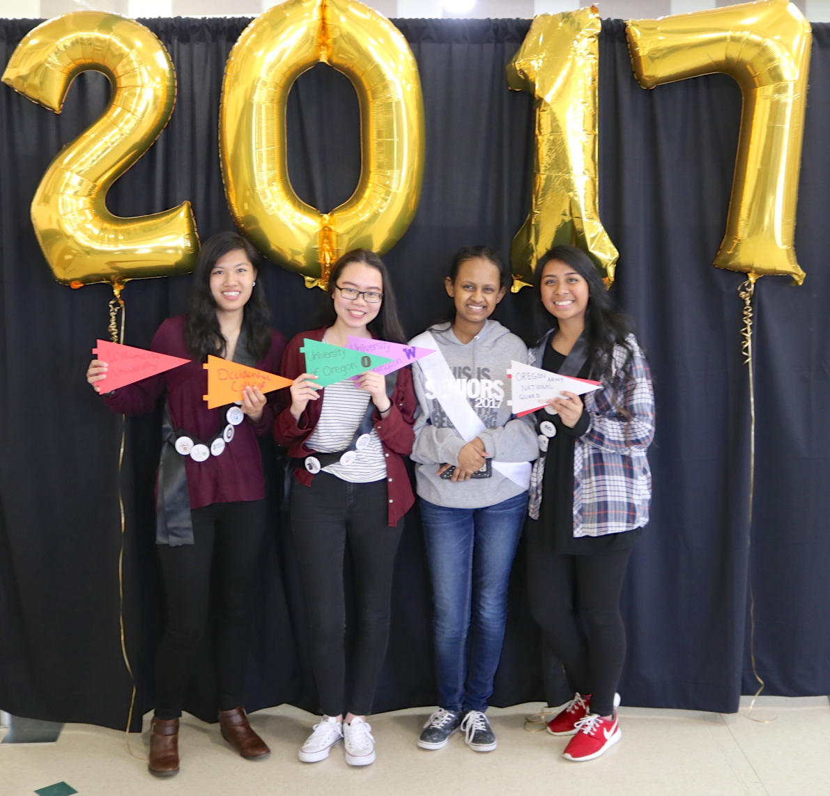Senior Signing Day 2017 Senior students holding paper pennants for the colleges they are to attend, with 2017 balloons behind them